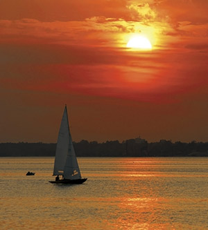 sailing with a yacht in sunset